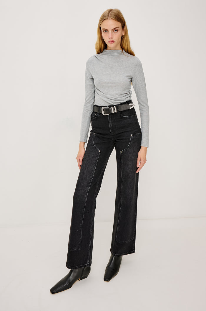 Joelle Top in Brushed Rib Jersey With Subtle Mock Neck, Fitted Silhouette, Side Shirring, and Long Sleeves in Heater Grey Colorway - Full Body Front View Featued on Model