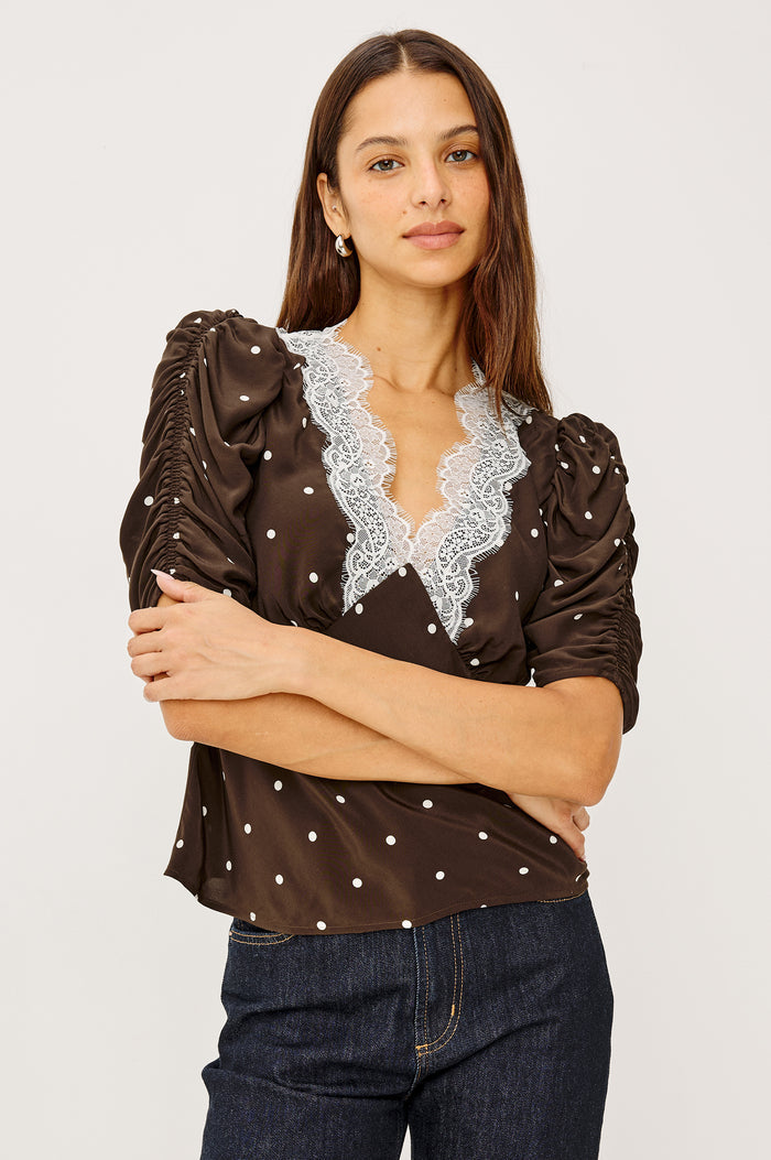 Lazara Top in Crepe With Lace Trim V-Neckline and Three-Quarter Puff Sleeves With Ruching in Cocoa Polka Dots Colorway - Upper Body Front View Featured on Model
