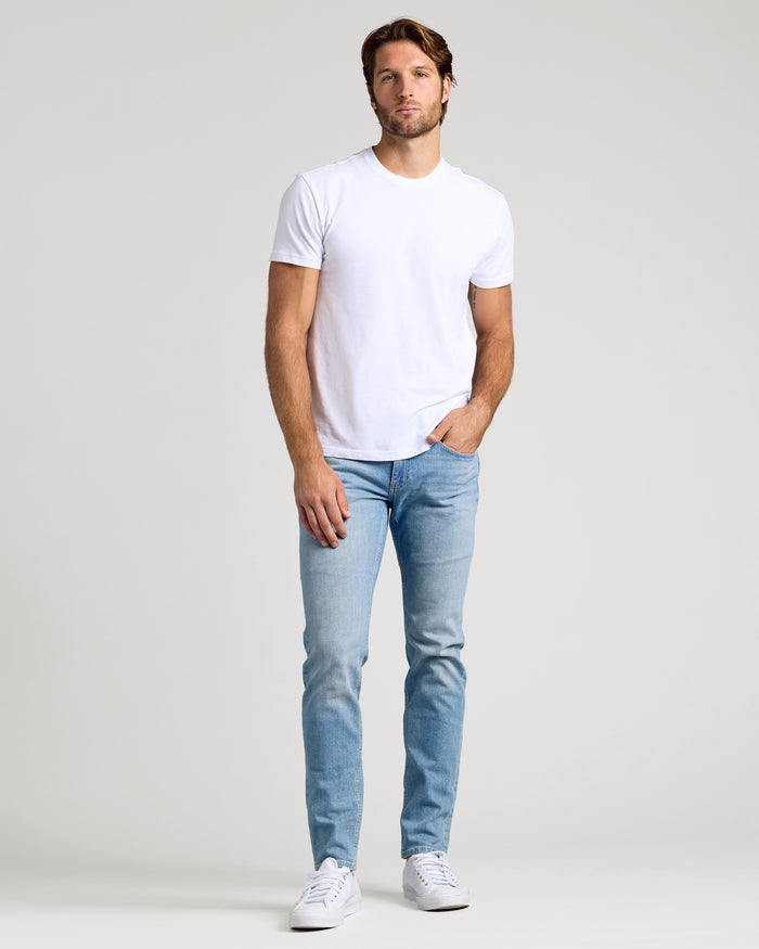 Young man wearing Light Indigo Wash Slim Authentic Denim Jeans.