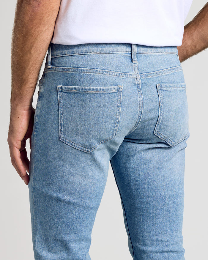Light Indigo Wash Slim Authentic Denim Jeans showing back pockets and slim fit.