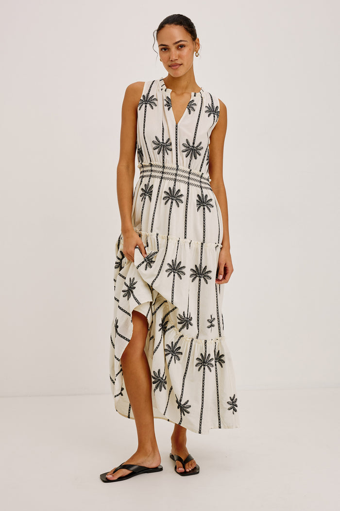 Loulou Maxi Dress in Cotton Voile With Ruffle Trim, V-Neck, Smocked Waist, and Ruffle Tier Skirt in Embroidered Palms Colorway - Full Body Front View Featured on Model