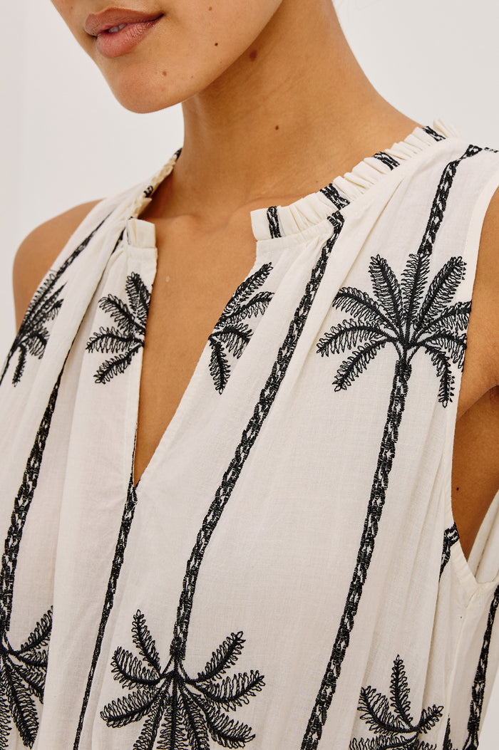 Loulou Maxi Dress in Cotton Voile With Ruffle Trim, V-Neck, Smocked Waist, and Ruffle Tier Skirt in Embroidered Palms Colorway - Upper Body Front View Featured on Model