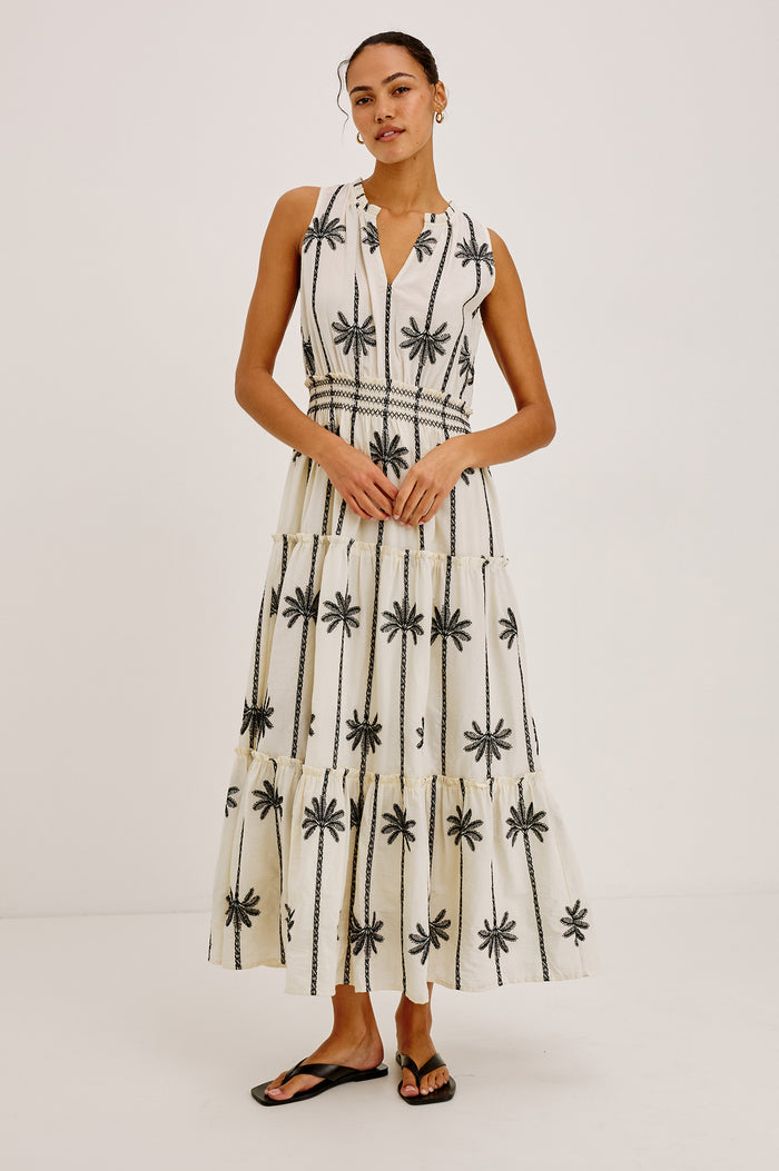 Loulou Maxi Dress in Cotton Voile With Ruffle Trim, V-Neck, Smocked Waist, and Ruffle Tier Skirt in Embroidered Palms Colorway - Full Body Front View Featured on Model