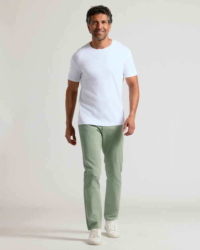 Man wearing Meadow Slim Twill Chino Pant walking confidently.