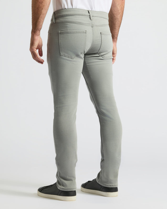 Back view of Medium Gray Wash Slim Comfort Stretch Jeans with black sneakers.