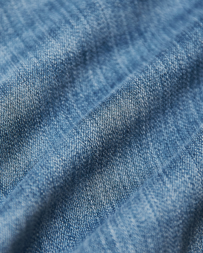 Medium Indigo Wash Slim Comfort Stretch Jeans close-up, showing detailed denim texture.