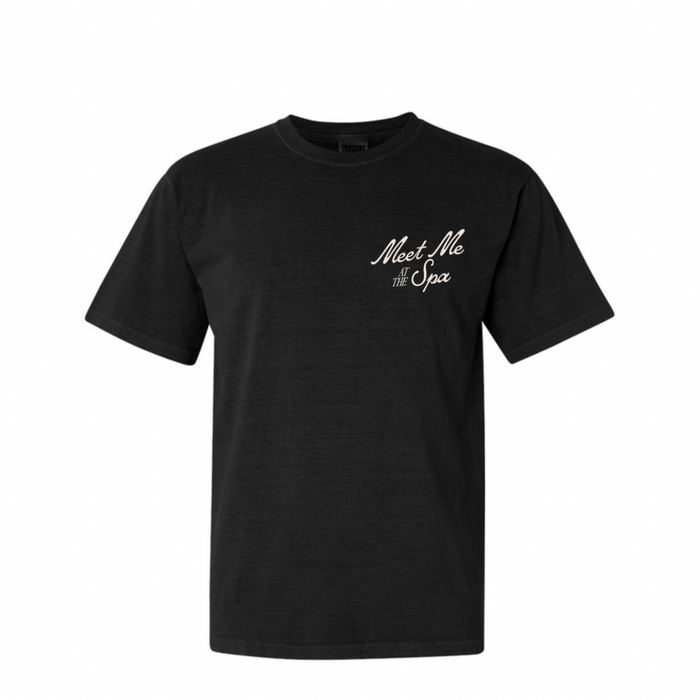 Black unisex t-shirt with a retro-inspired "Meet Me At The Spa" text design on the chest, ideal for casual wear and representing wellness and relaxation lifestyle. Meet Me At The Spa Retro Unisex T-Shirt | Lucky Owl