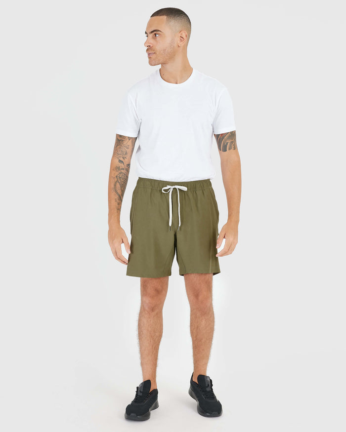 Man wearing Military Green Active Quick Dry Shorts with Liner, white T-shirt.