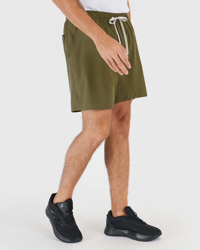 Military Green Active Quick Dry Shorts with Liner, worn with black sneakers.