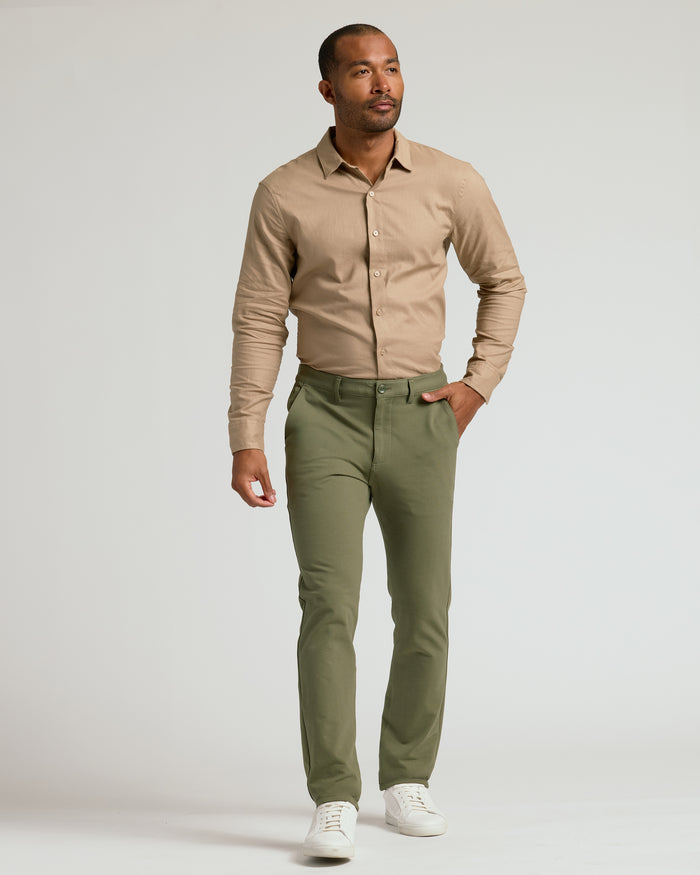 Man wearing Military Green Slim Chino Pants 2.0 with white sneakers.