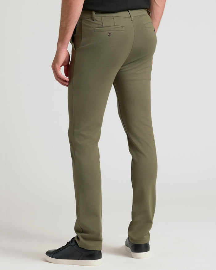 Military Green Slim Comfort Knit Chino Pant with black sneakers visible.