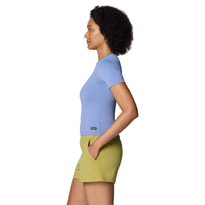 Woman in a fitted, ribbed periwinkle short-sleeve tee with a small logo, paired with olive shorts.