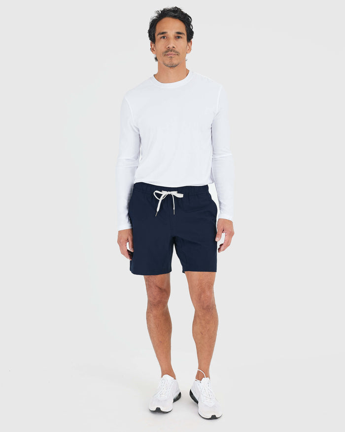 Man wearing Navy Active Quick Dry Shorts with Liner and white shirt.