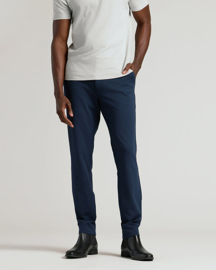 Male model wearing Navy Commuter Pants with black Chelsea boots.