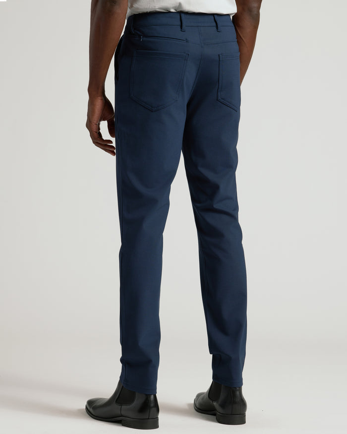 Navy Commuter Pants styled with white shirt and Chelsea boots.