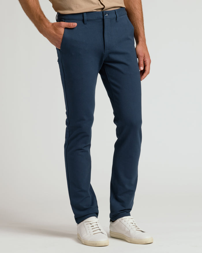 Navy Slim Chino Pants 2.0 with white sneakers.