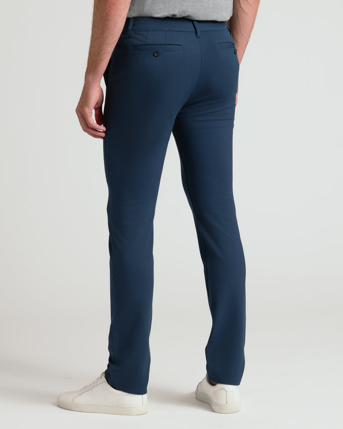 Back view of Navy Slim Comfort Knit Chino Pant modeled.