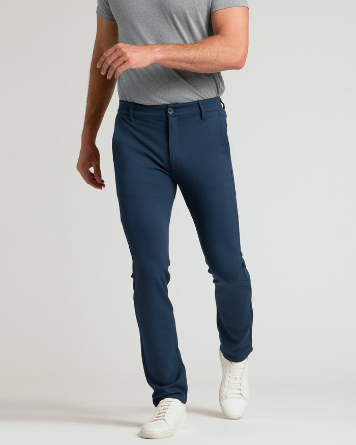 Navy Slim Comfort Knit Chino Pant on man with white sneakers.