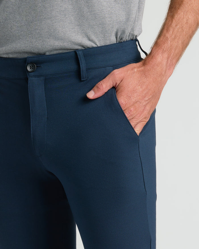 Navy Slim Comfort Knit Chino Pant with gray T-shirt tucked in.