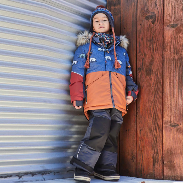 Boy wearing Deux par Deux grizzly print snowsuit outdoors for skiing, sledding, and winter play.