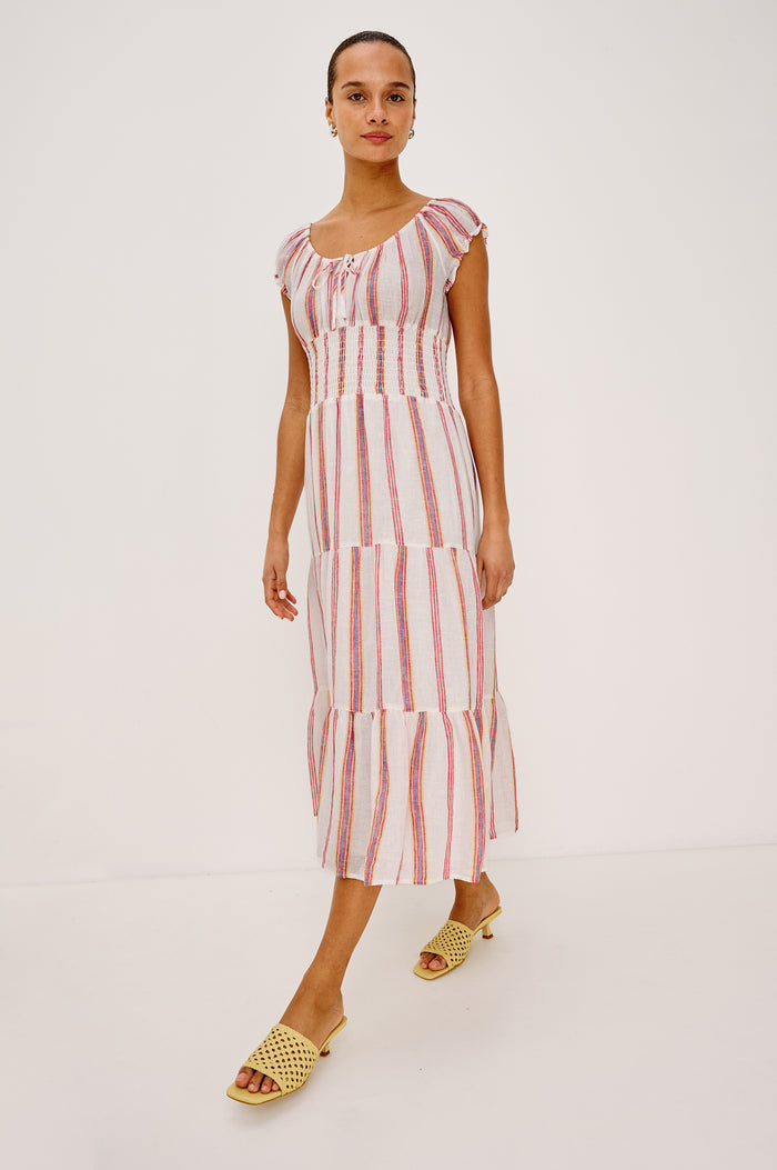 Daria Dress in Luxe Linen With Cap Sleeves, Scoop Neckline, Bust Ties, Smocked Waist, and Tiered Skirt in Primavera Stripe Colorway - Full Body Front View Featured on Model