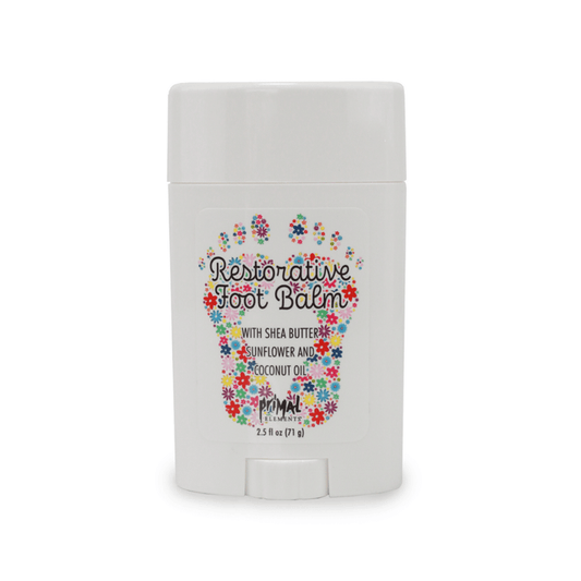 Restorative Foot Balm | Primal Elements in a white stick container with colorful floral foot design, highlighting shea butter, sunflower, and coconut oil for skincare and body care.
