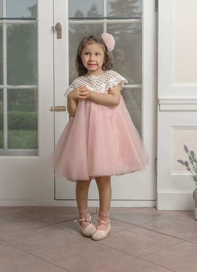 Child wearing Rosa pink tulle flower hair clip styled with a blush pink dress, perfect for special occasions and formal outfits