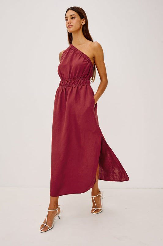 Selani Midi Dress in Linen-Viscose Blend With One-Shoulder Neckline, Laddered Elastic Waist, Side Slits, Side Pockets, and Softly Voluminous Skirt in Spice Colorway - Full Body Front View Featured on Model