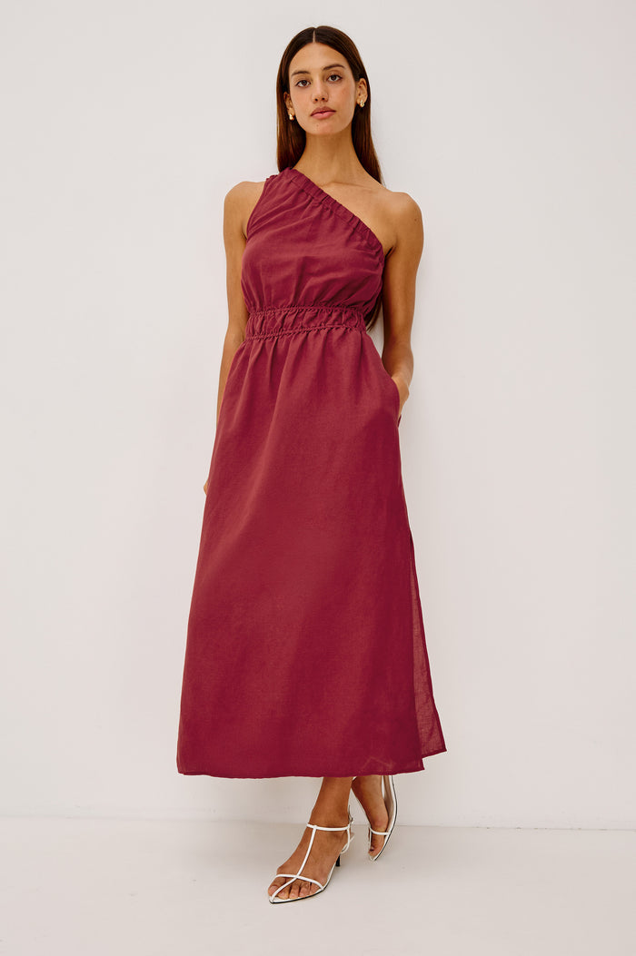Selani Midi Dress in Linen-Viscose Blend With One-Shoulder Neckline, Laddered Elastic Waist, Side Slits, Side Pockets, and Softly Voluminous Skirt in Spice Colorway - Full Body Front View Featured on Model