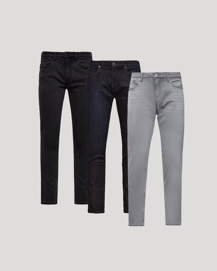 Three pairs of men's Slim Comfort Stretch Jeans 3-Pack in black, dark blue, and light grey, displayed against a plain background showcasing a modern slim fit style.