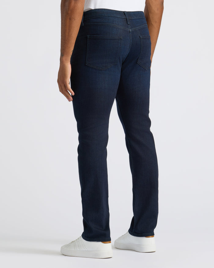 Medium Gray Wash Slim Comfort Stretch Jeans with white sneakers and shirt.