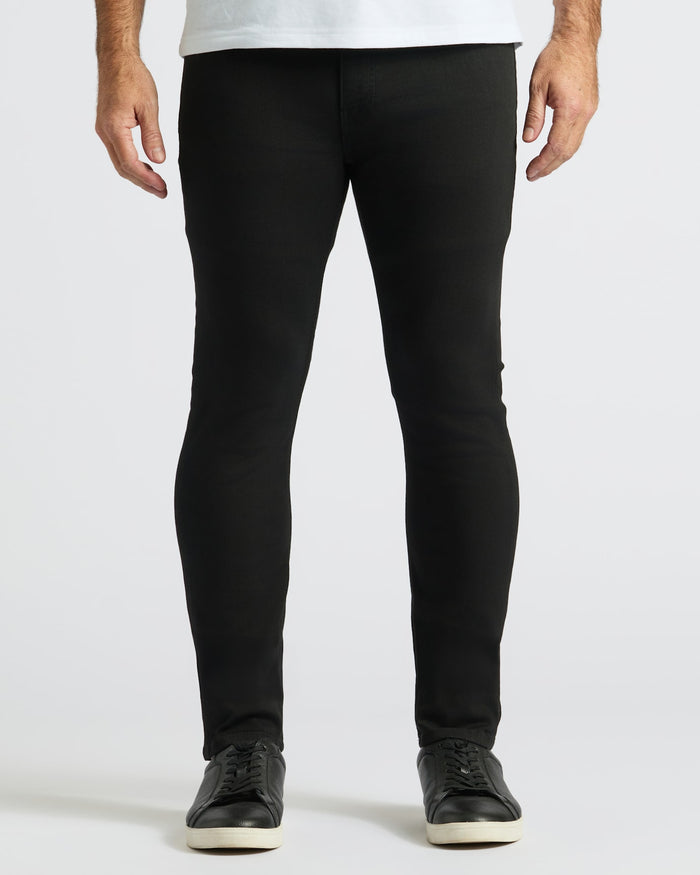 Slim Indigo & Black Comfort Stretch Jeans 2-Pack with black sneakers.