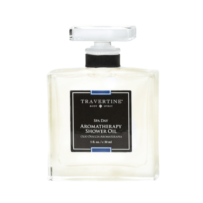 Clear glass bottle of Spa Day Aromatherapy Shower Oil | Travertine with a black label and white text, designed for skincare and wellness use.
