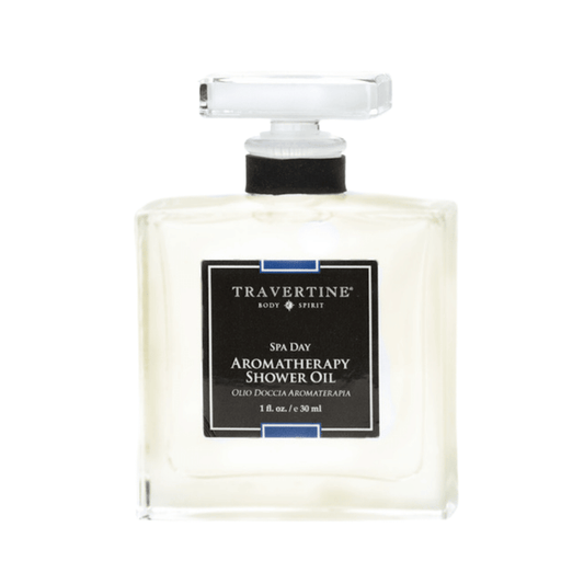 Clear glass bottle of Spa Day Aromatherapy Shower Oil | Travertine with a black label and white text, designed for skincare and wellness use.