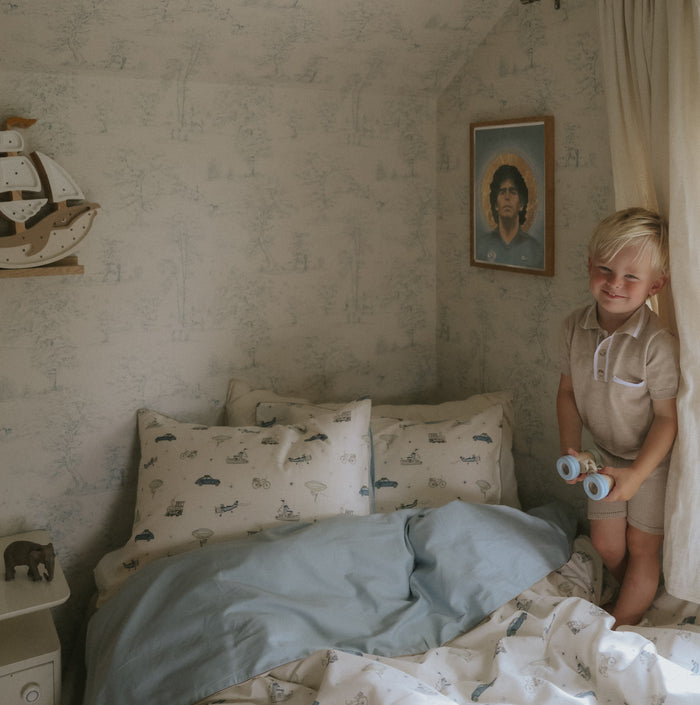Transport Treasures Standard Pillowcase in Blue with little boy in bed.